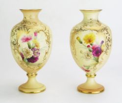A pair of Royal China Works, Worcester blush ivory vases of ovoid form, with painted floral spray