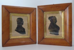 A pair of Regency period silhouettes of a lady and gentleman, heightened in gilt and contained in