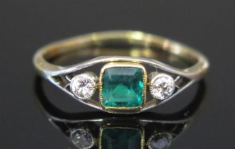 A Diamond and Green Stone or Paste Three Stone Ring in a precious yellow and white metal