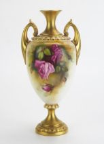 A Royal Worcester blush ivory twin-handled vase, of ovoid form with painted rose pattern decoration,