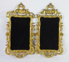 A pair of late 18th century gilt wood wall mirrors of arched outline, with arched stalactite