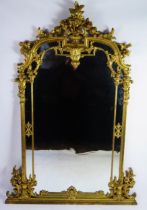 A Louis XV style gilt wood pier glass of arched outline surmounted by a vase for flowers and