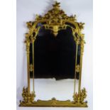 A Louis XV style gilt wood pier glass of arched outline surmounted by a vase for flowers and