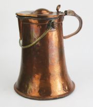 A 19th century copper water jug and cover, of cylindrical tapering form, with loop carrying handle