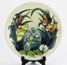 A Moorcroft pottery plate with piped Lamia decoration by Rachel Bishop, 26cm diameter.