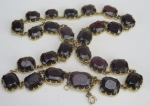 An Antique Graduated Red Amethyst? Necklace in a precious yellow metal setting, largest stone c.