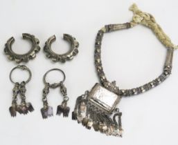 A middle eastern silver necklace with amulet box with chain suspensions, two silver amulets and a