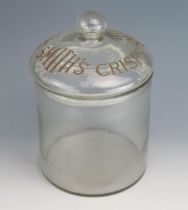 A clear glass advertising jar and cover for 'Smiths Crisps' of cylindrical outline, with domed