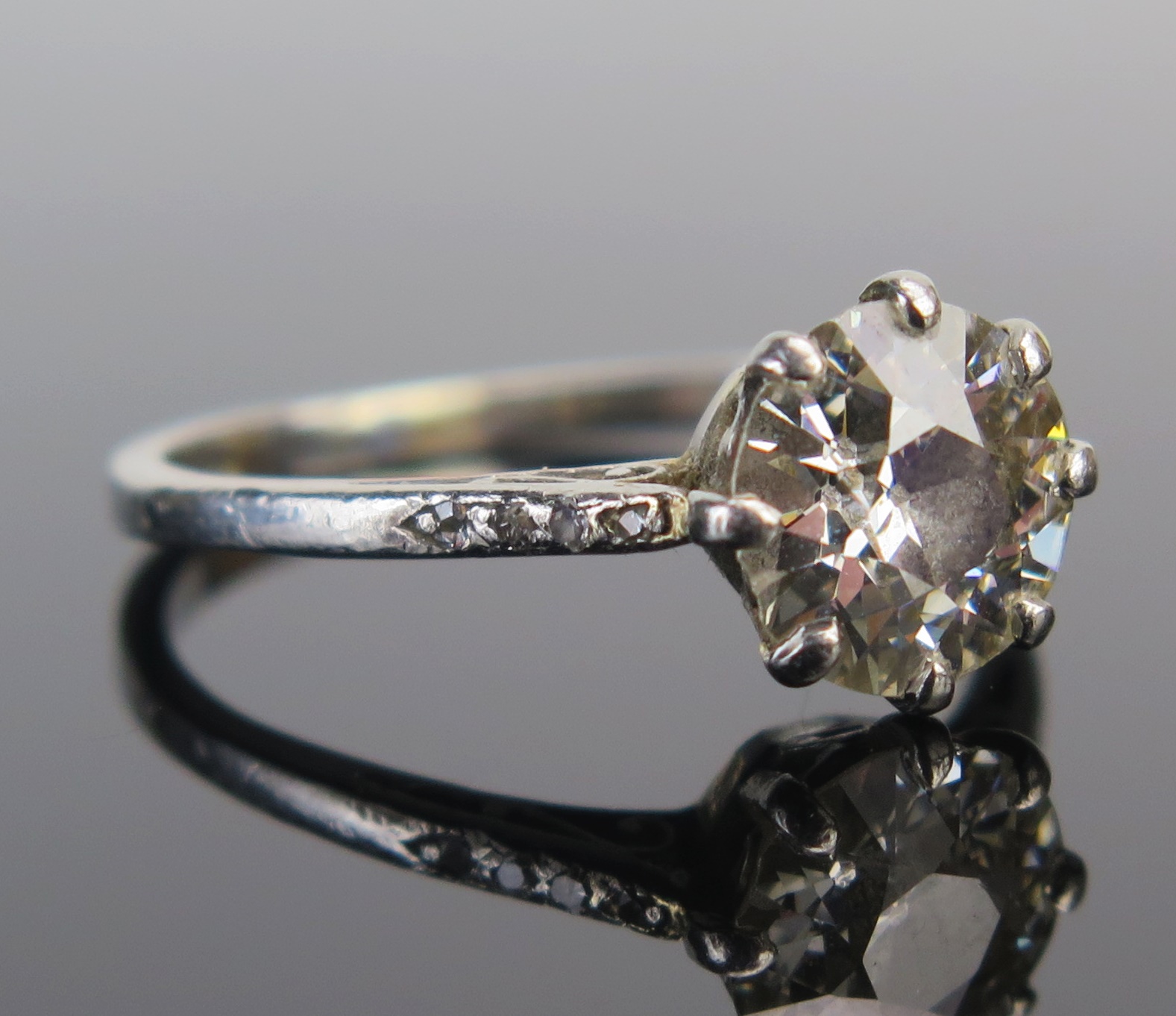 A Diamond Solitaire Ring in a precious white metal setting, the c. 8.1mm old European cut stone in a - Image 2 of 3