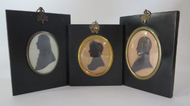 A three Regency period silhouettes of a lady and two gentleman, contained in ebonised frames, 9 x