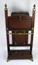 A Victorian Schoolbred style oak stick stand, the rectangular back with brass finials, with single