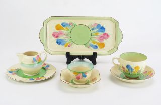 A Clarice Cliff Crocus pattern part tea set, includes cup, saucer, side plate, cream jug, dish and