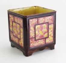 An aesthetic period majolica jardinière, of square form, the panels decorated with birds, flowers