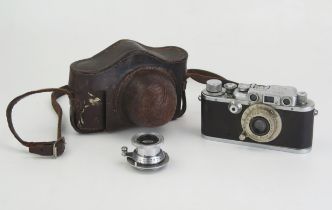 A Leica III B camera, fitted with Leitz Elmar 1:3,5F=50mm lens, serial No 265080, in leather case,