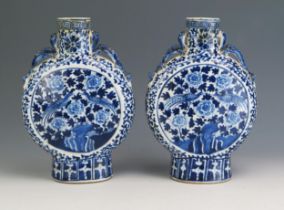 A pair of Chinese blue and white porcelain moon flasks, of traditional design with dragon handles,