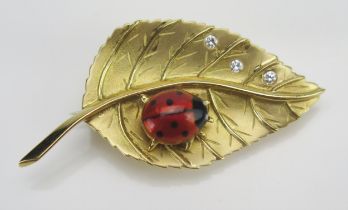 A Modern 18ct Gold, Diamond and Enamel Ladybird and Leaf Brooch, 44.1mm long, Birmingham 2002, maker