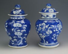 A Chinese blue and white vase and cover, of ovoid form with all over prunus decoration, bears four