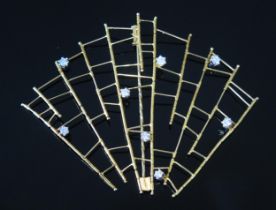 * A Modernist 18ct Gold and Diamond Articulated Fan Shaped Brooch hinged at each vertical axis,