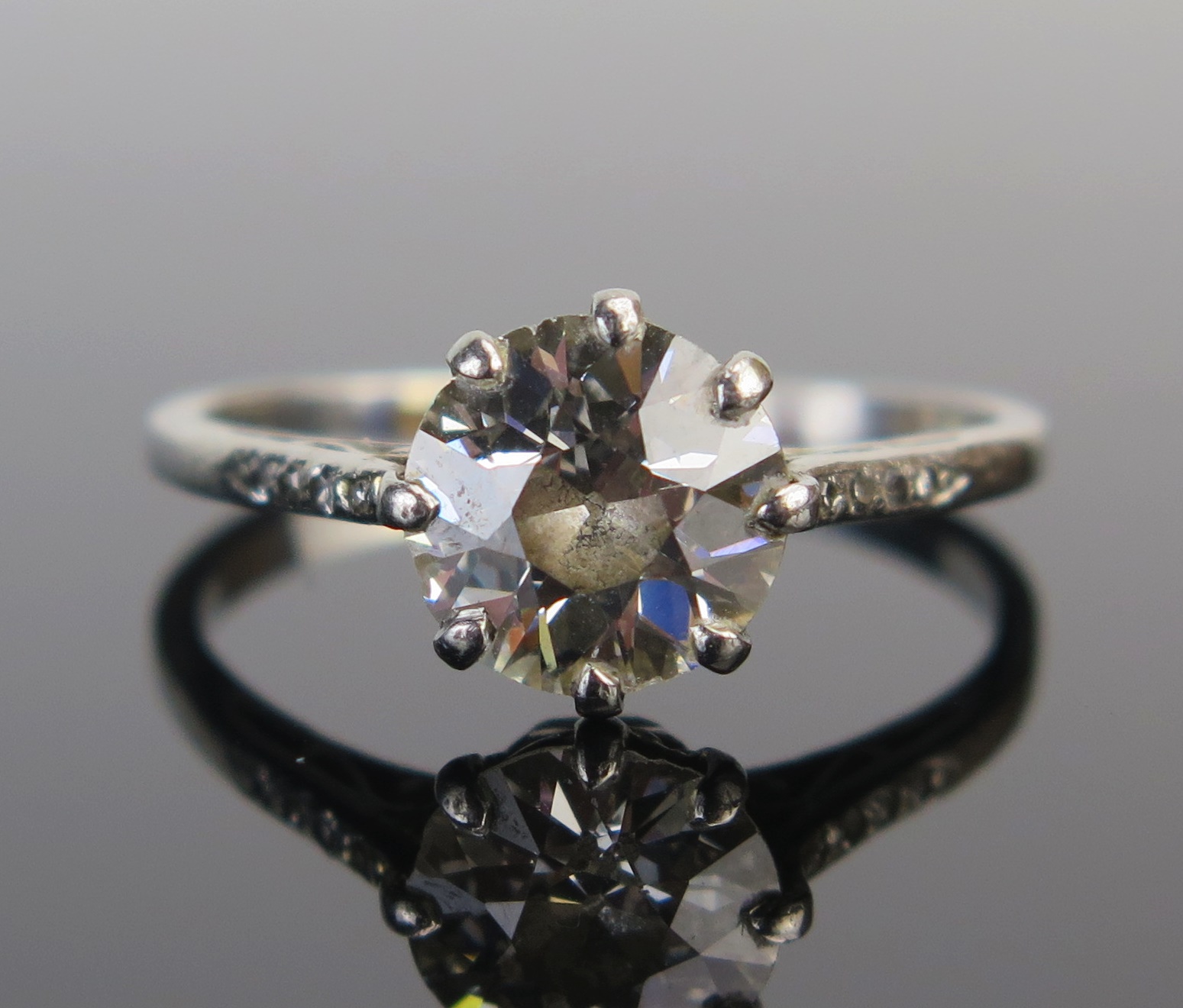 A Diamond Solitaire Ring in a precious white metal setting, the c. 8.1mm old European cut stone in a