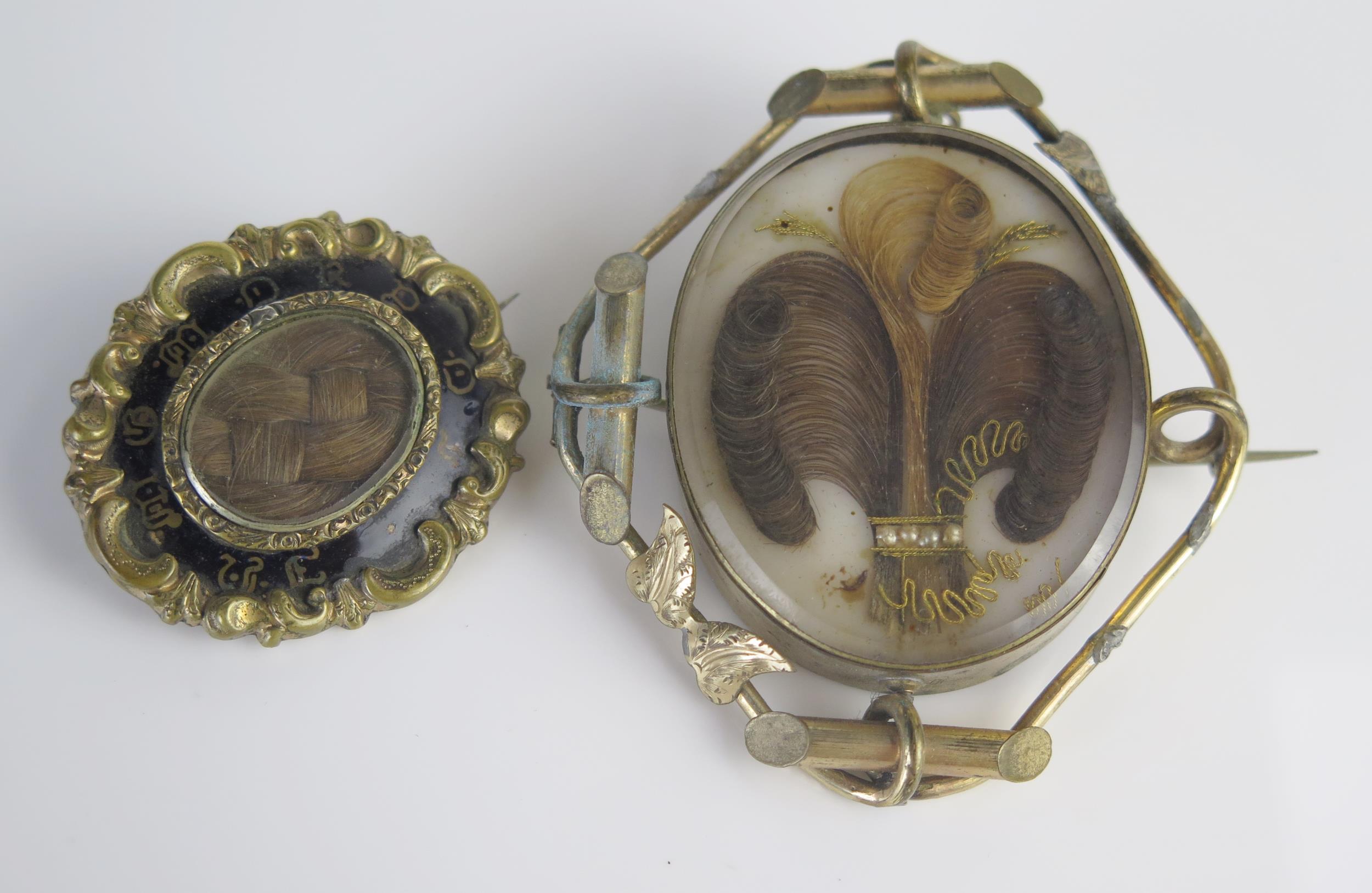 Two Victorian Memorial Brooches including one set with a plume of hair embellished with gold