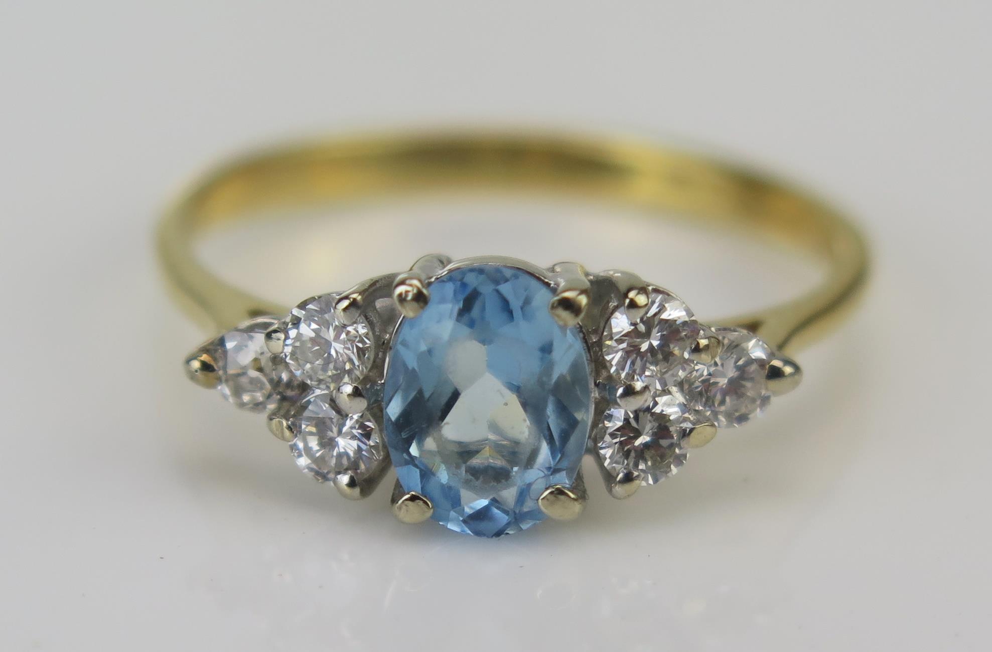 An 18ct Gold, Diamond and Blue Stone Ring, c. 15.7x7mm head, stamped 750 with London import marks,
