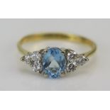 An 18ct Gold, Diamond and Blue Stone Ring, c. 15.7x7mm head, stamped 750 with London import marks,