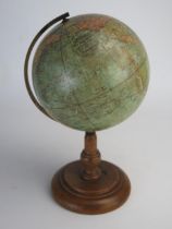 A Johnson's six inch terrestrial globe, on brass frame and turned wood circular base, overall height