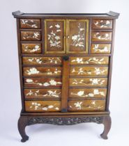 A Japanese hardwood, ivory and mother-of-peal inlaid curiosity cabinet, of rectangular outline