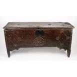 A 17th century elm coffer, of rectangular outline, the hinged lid with moulded and chip carved edge,