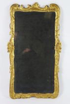 A late 18th century gilt and gesso pier glass, the rectangular mirror plate enclosed by floral and