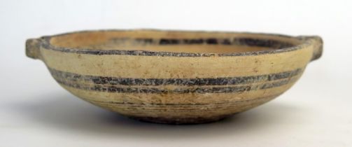 A Cypro archaic period kylex form bowl, probably Greek, with loop handles to the sides, plain banded