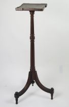 An Edwardian mahogany torchiere stand with square top raised on a fluted and knopped column and