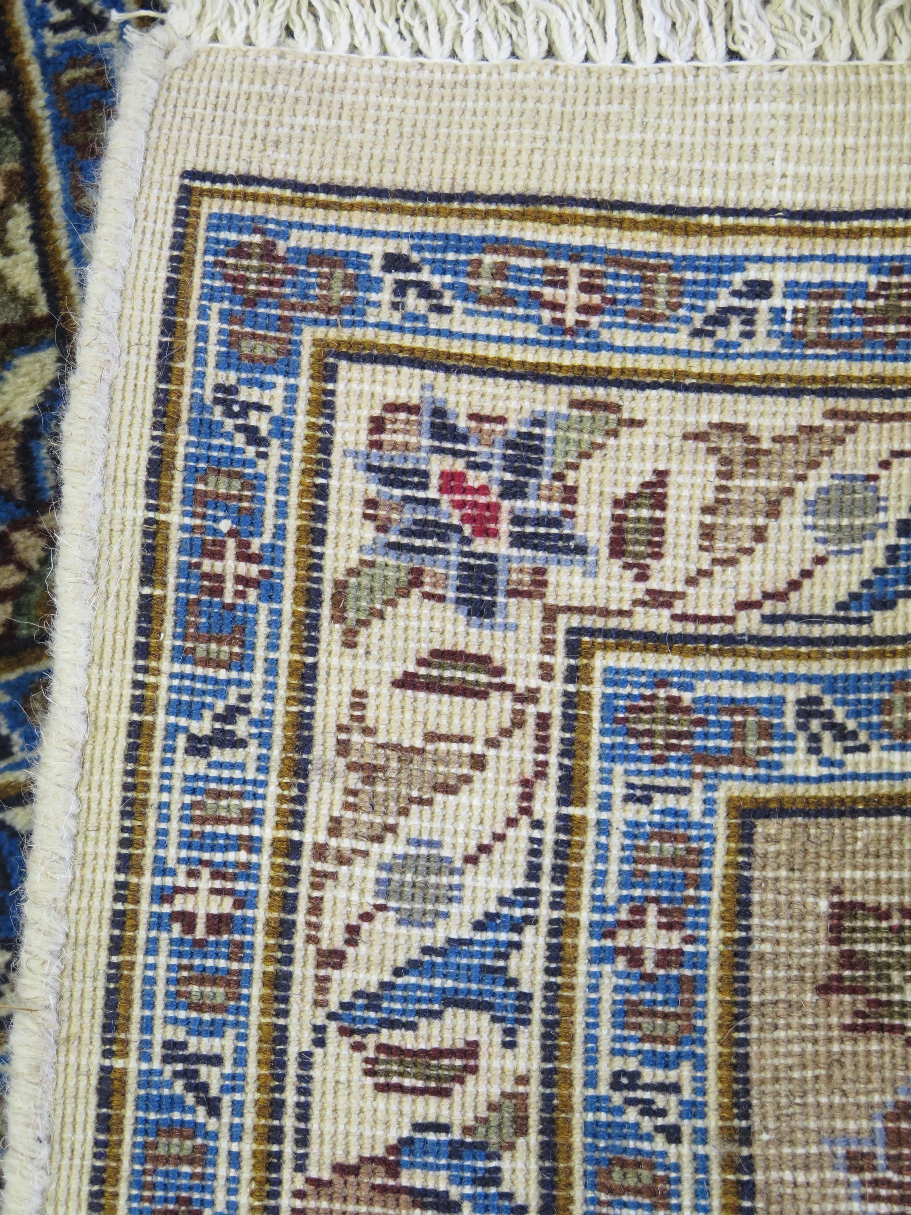 A Meshed rug, the ivory field with central circular floral medallion, with biege floral spandrels - Image 4 of 4