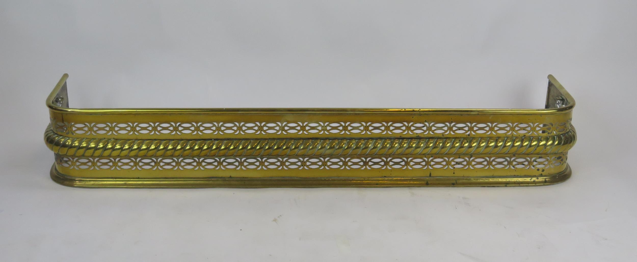 A 19th century brass fire kerb of rectangular outline, with pierced banded and rope twist