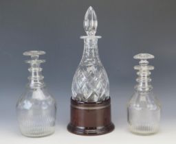 A 19th century glass decanter with triple ring neck and mallet shape, 23.5cm high, another similar