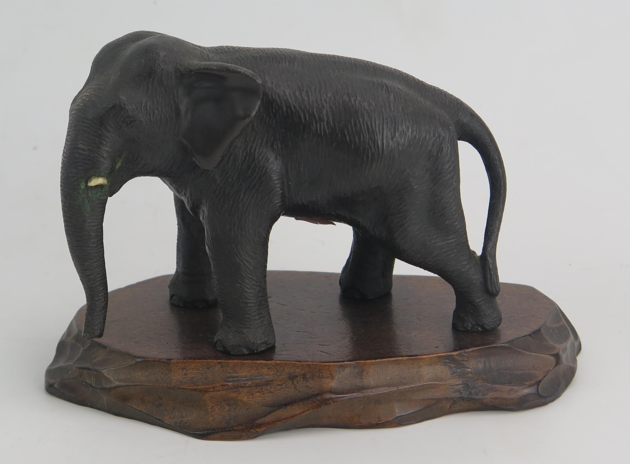 A Japanese Meiji Period Bronze Elephant (12cm long) and on a carved wooden stand and one signed - Image 2 of 3