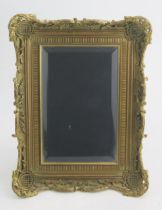 A 19th Century Gilt Metal Strut Mirror with finely case and pierced foliate scroll border,