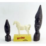 Two African carved wood busts, 26cm and 16cmmhigh, together with a plastic advertising figure for