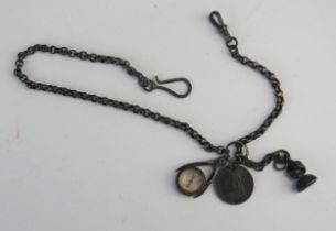 A white metal chain with seal, compass and Victorian sixpence.