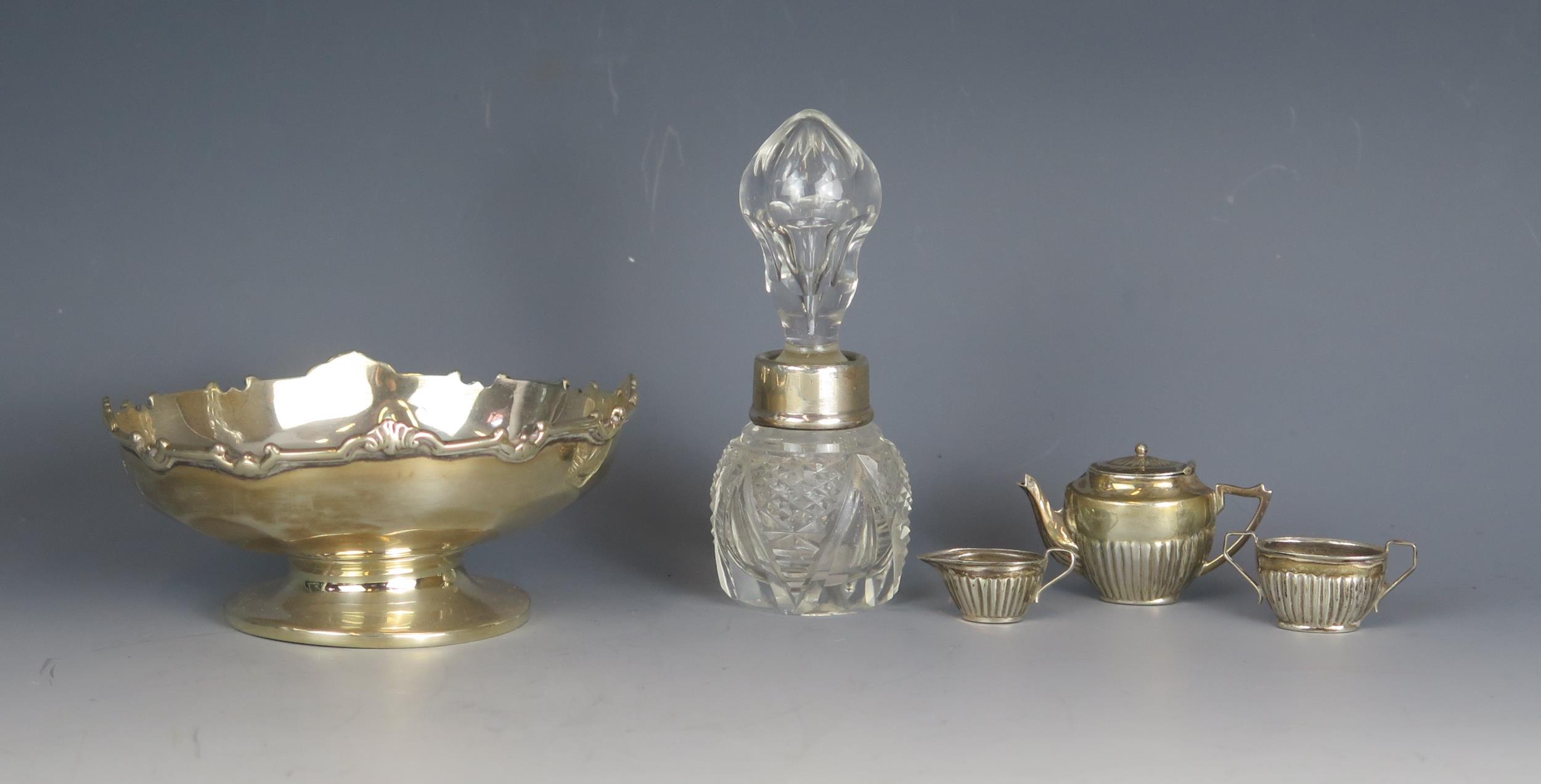 A mixed collection of silver items, various makers and dates, includes a miniature three-piece tea