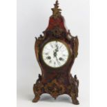 A scarlet tortoiseshell and brass cut decorated mantel clock of cartouche-shaped outline, the Boulle