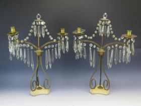 A pair of 19th century gilt metal twin branch candelabra, with glass prismatic suspensions,