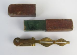 A pair of brass sovereign and half-sovereign scales, contained in a Morocco leather bound box.