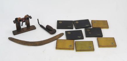 An Australian boomerang, 56cm long, four assorted smokers pipes together with Players Navy Cut