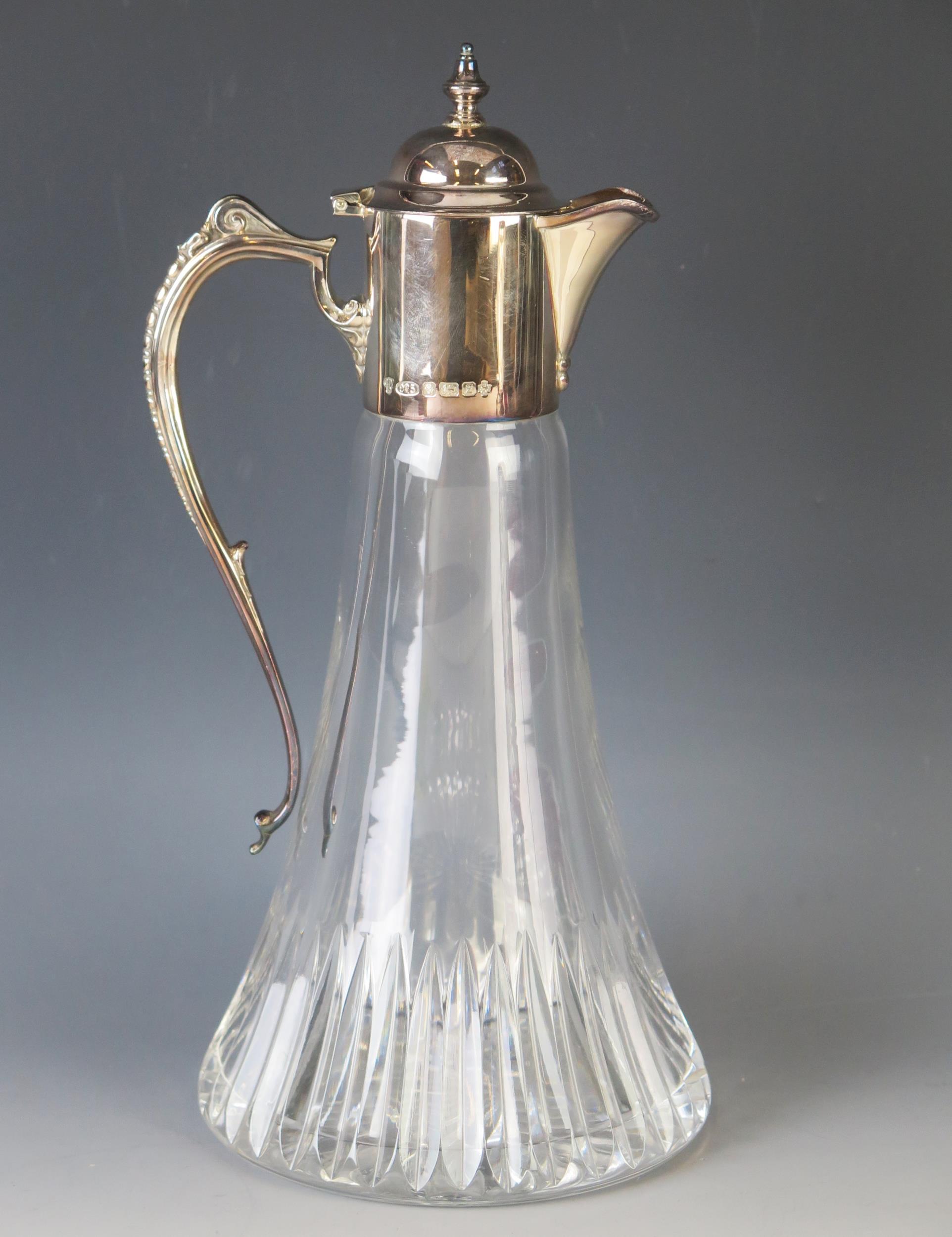 An Elizabeth II clear glass and silver mounted claret jug, maker C J Vander Ltd, Sheffield, 2000, of