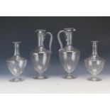 Two Edwardian etched glass wine ewers, of ovoid form with slender neck and scroll handle raised on a