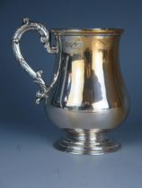 A Victorian silver christening mug, maker Henry Holland, London, 1869, initialled, of baluster form,