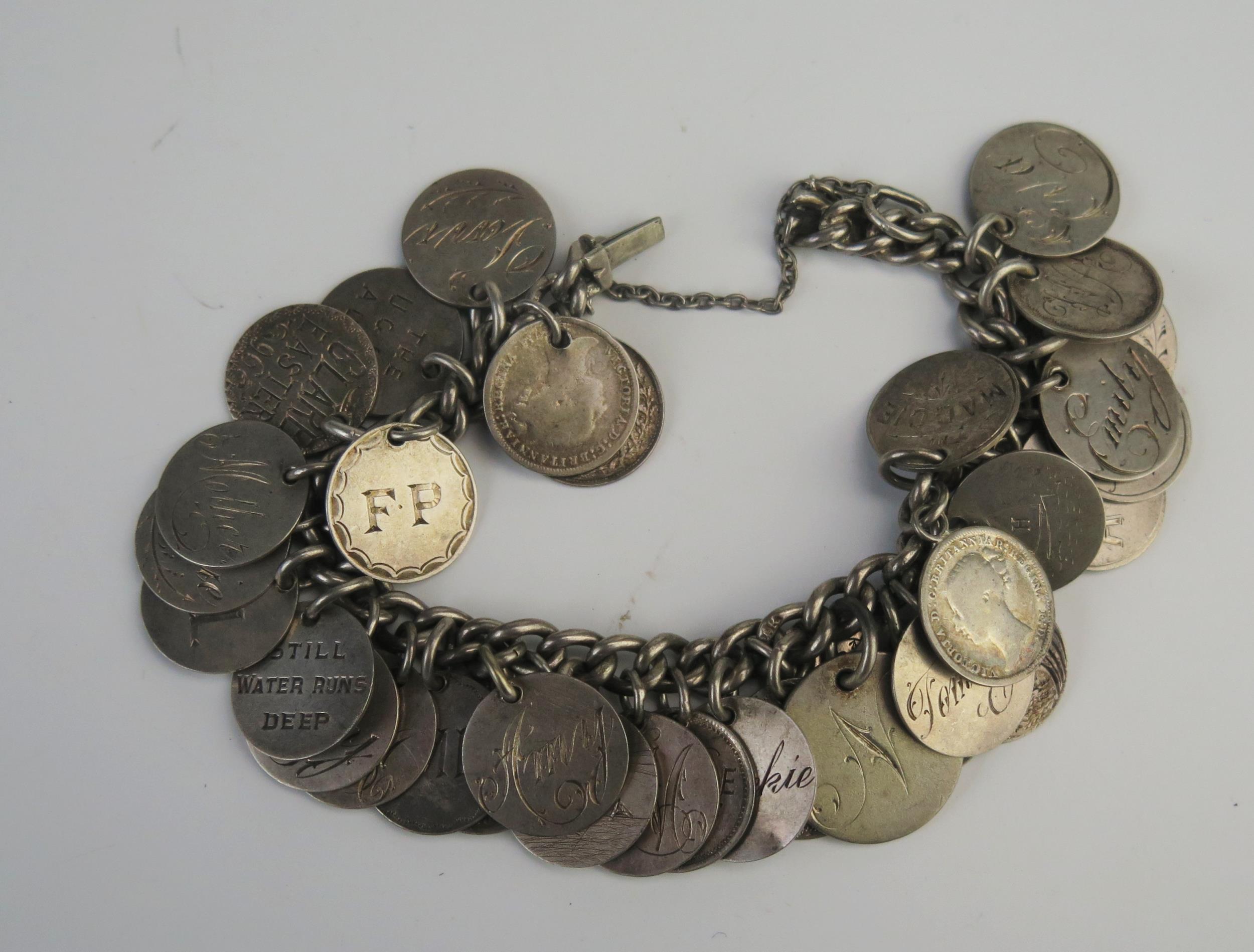 A silver coin bracelet, 15cm long with safety chain, 67gms, 2.16ozs