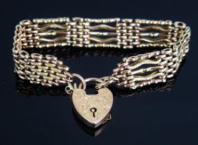 A 9ct Gold Gate Link Bracelet with 'padlock' clasp having chased foliate scroll decoration,