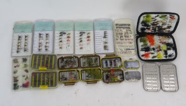 A collection of assorted trout and sea trout flies, including wet and dry flies, lures and nymphs,